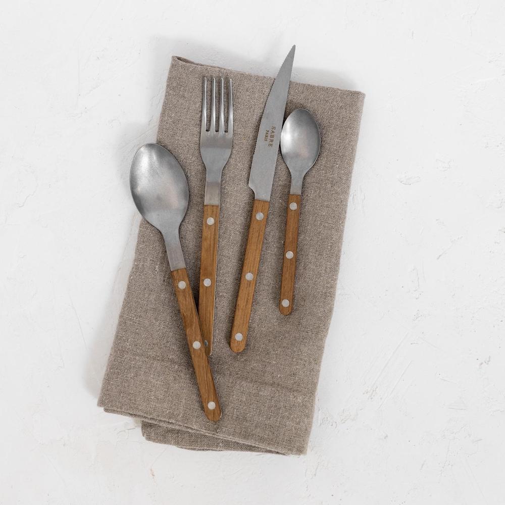 Sabre cutlery flatware set on oversized linen napkins
