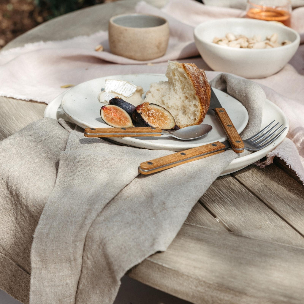large oversized linen napkins on table with stoneware salad plates and Sabre flatware