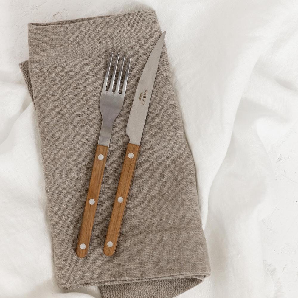 Sabre cutlery flatware on oversized linen napkins